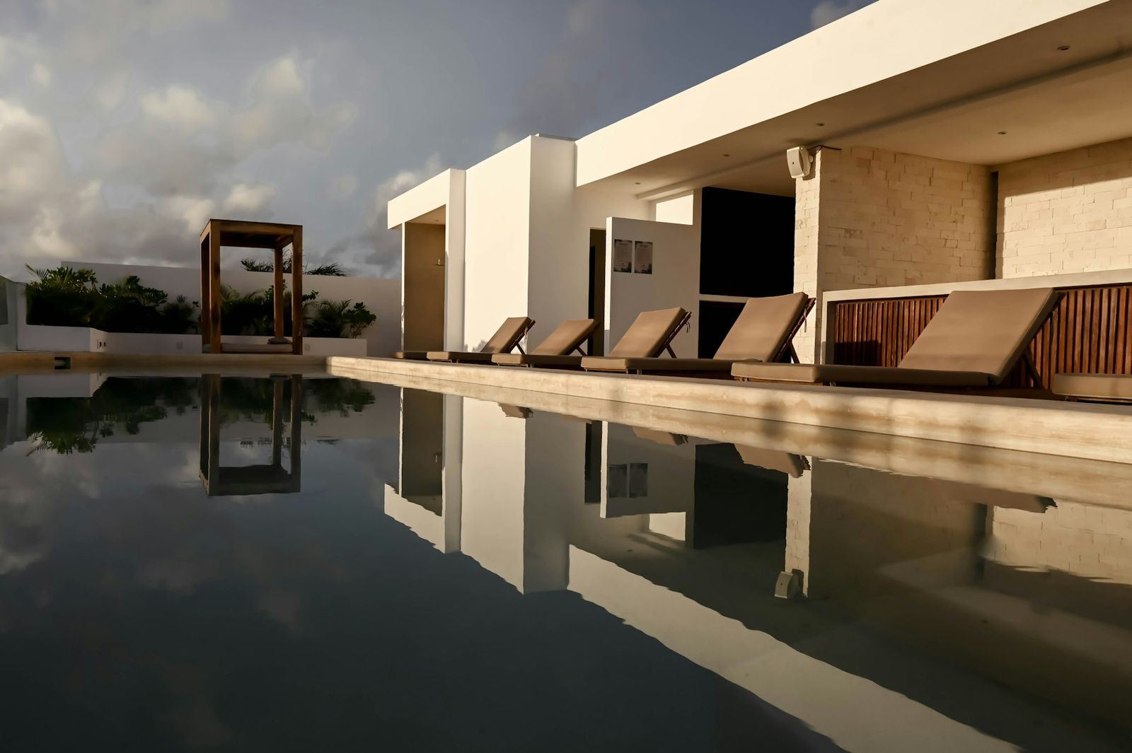 A long pool beside a terrace at dusk